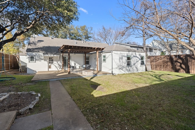 rear view of house with a yard, a patio, an outdoor structure, and a pergola