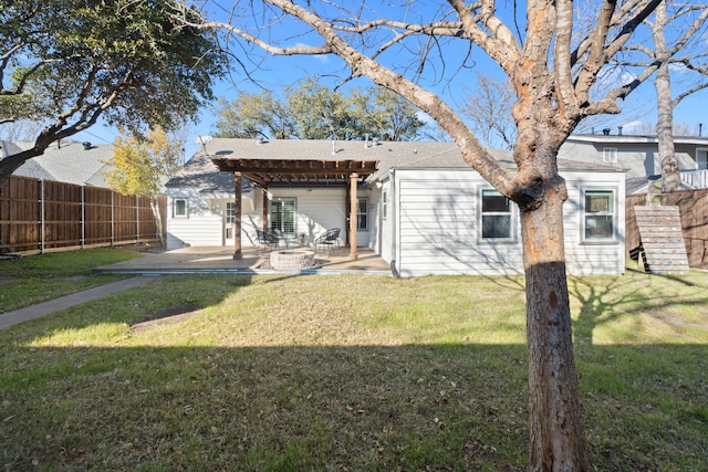 rear view of house with a lawn and a patio