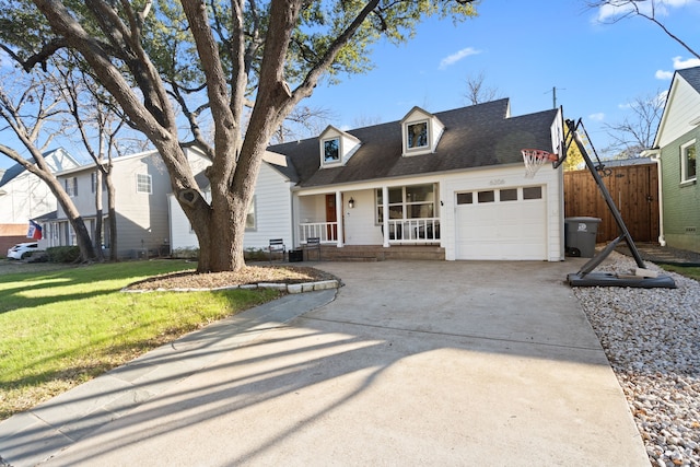 view of front of house featuring a porch, a garage, and a front yard