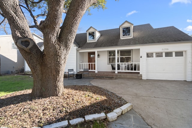 cape cod home with a garage, cooling unit, and a porch