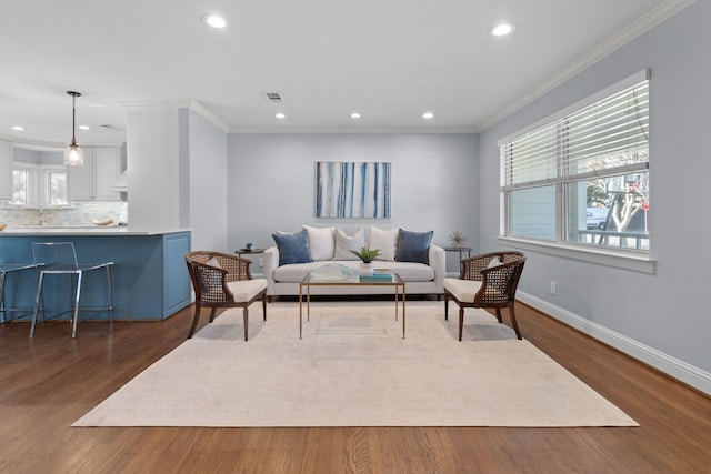 living room with dark hardwood / wood-style flooring and ornamental molding