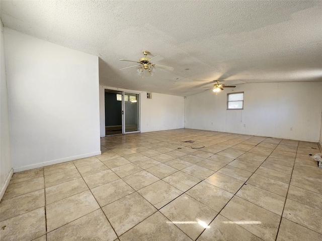 empty room featuring ceiling fan, a textured ceiling, and light tile patterned flooring