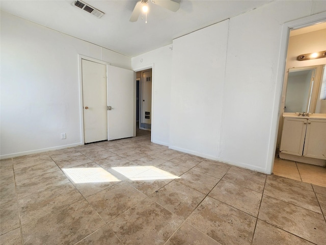 spare room featuring sink and ceiling fan