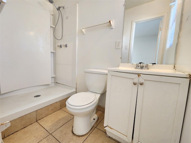 bathroom featuring vanity, walk in shower, tile patterned floors, and toilet