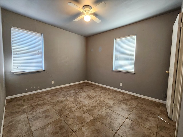 spare room featuring ceiling fan and tile patterned flooring