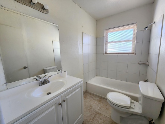 full bathroom featuring vanity, toilet, tile patterned floors, and tiled shower / bath combo