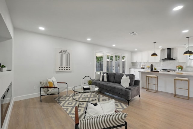 living room with light wood-type flooring and french doors