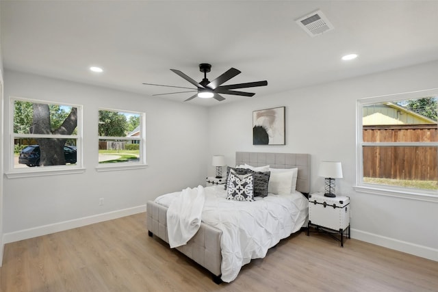 bedroom with ceiling fan and light wood-type flooring