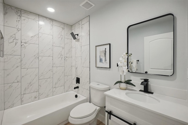 full bathroom with tiled shower / bath combo, toilet, and vanity