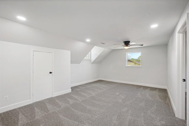 bonus room with carpet floors, ceiling fan, and vaulted ceiling