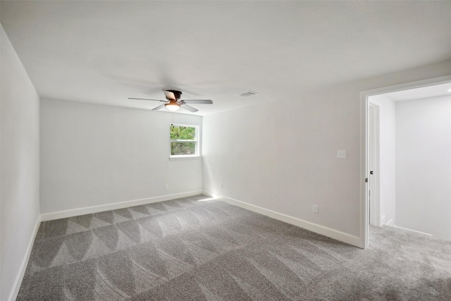 spare room with ceiling fan and carpet