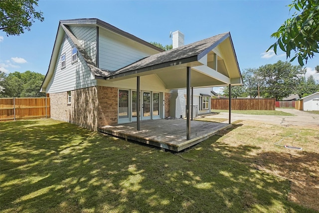 rear view of house with a lawn