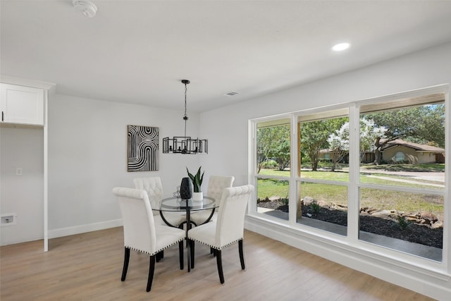 dining room featuring an inviting chandelier and light wood-type flooring