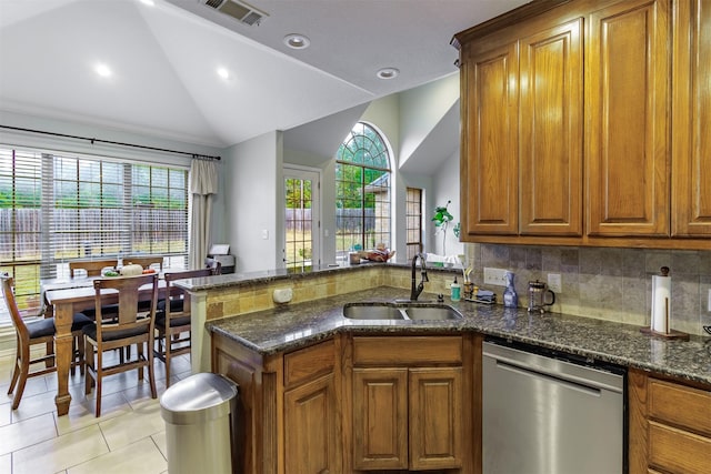 kitchen featuring sink, dishwasher, kitchen peninsula, and vaulted ceiling