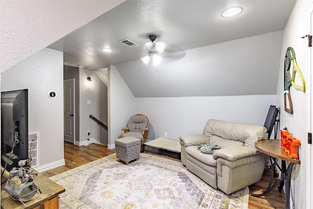 sitting room featuring vaulted ceiling, ceiling fan, a textured ceiling, and wood-type flooring