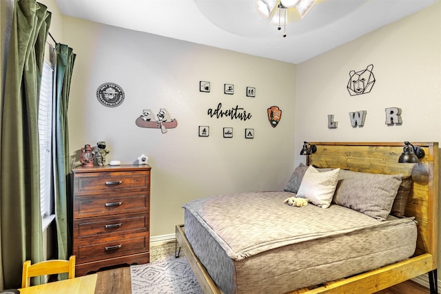 bedroom with ceiling fan and wood-type flooring