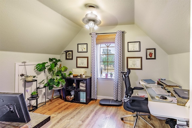 office featuring ceiling fan, light hardwood / wood-style floors, and lofted ceiling