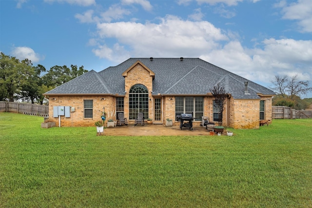 rear view of house featuring a patio area and a yard