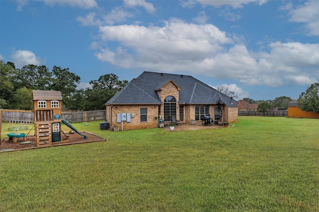 exterior space with a playground, a yard, and a patio area