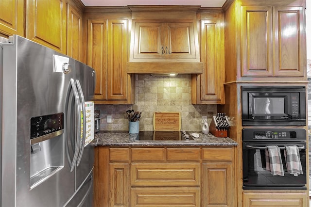 kitchen featuring backsplash, black appliances, and dark stone counters