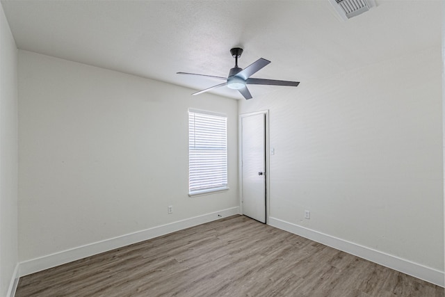 empty room with light hardwood / wood-style flooring and ceiling fan