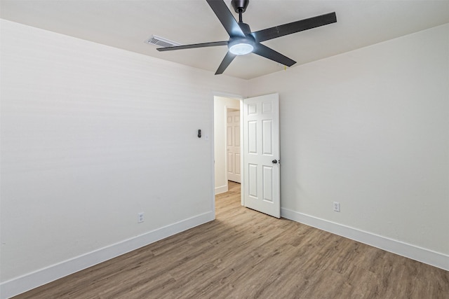 empty room featuring light wood-type flooring and ceiling fan