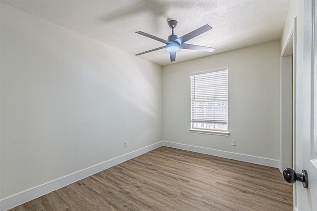 unfurnished room with ceiling fan and hardwood / wood-style floors