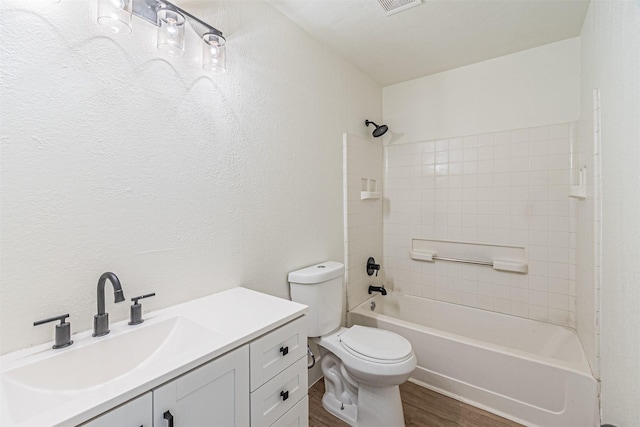 full bathroom with wood-type flooring, shower / tub combination, vanity, and toilet