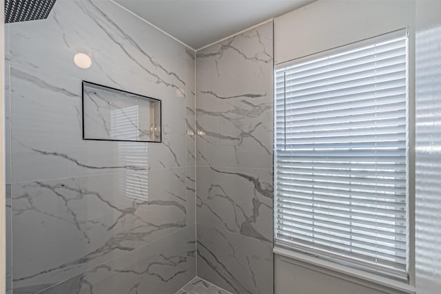 bathroom with a tile shower