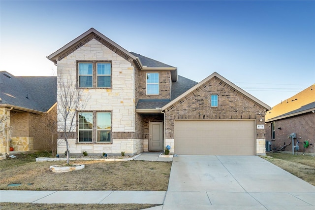 view of front of house featuring driveway, a shingled roof, stone siding, an attached garage, and brick siding