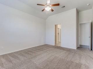 unfurnished bedroom with visible vents, vaulted ceiling, and light colored carpet