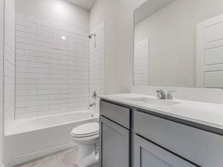 full bath featuring toilet, vanity, and bathing tub / shower combination