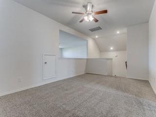 bonus room featuring lofted ceiling, carpet floors, ceiling fan, and visible vents