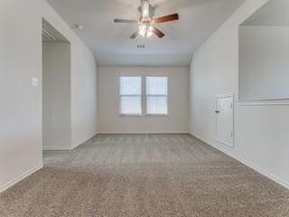 unfurnished room featuring vaulted ceiling, a ceiling fan, and light colored carpet