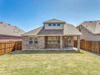 back of property with a patio, a lawn, and a fenced backyard