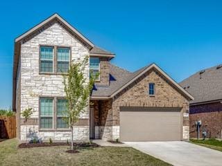 view of front of home with a front yard, stone siding, driveway, and an attached garage