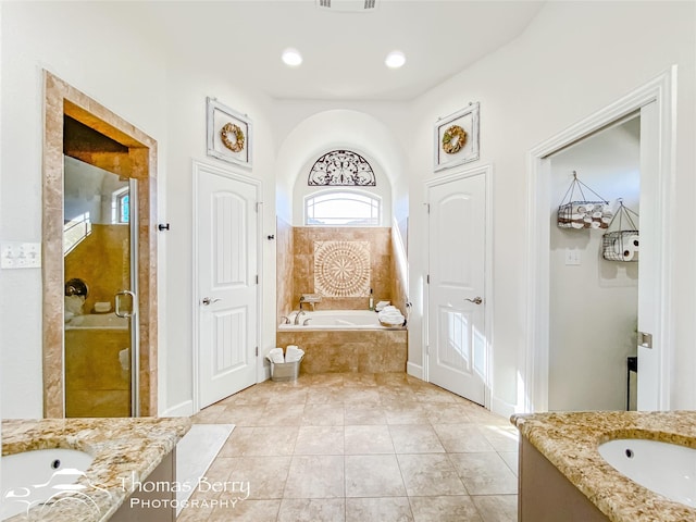 bathroom with tile patterned floors, vanity, and separate shower and tub