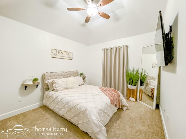 bedroom featuring light colored carpet and ceiling fan