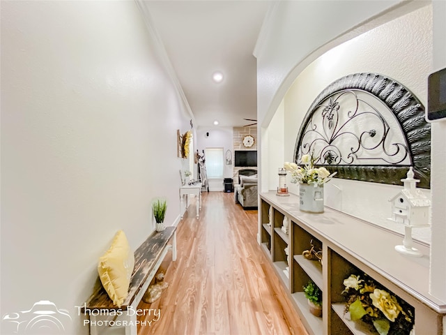 hallway with crown molding and hardwood / wood-style floors