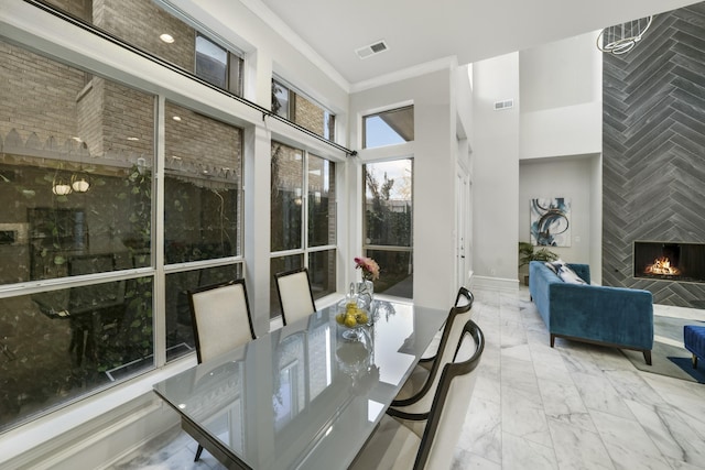 sunroom / solarium featuring a large fireplace