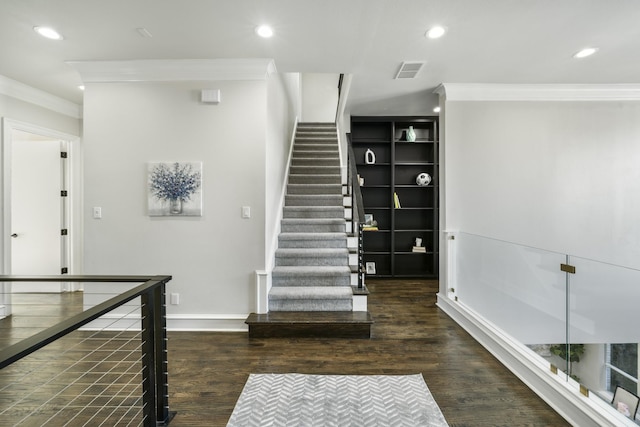 stairway featuring hardwood / wood-style floors and ornamental molding