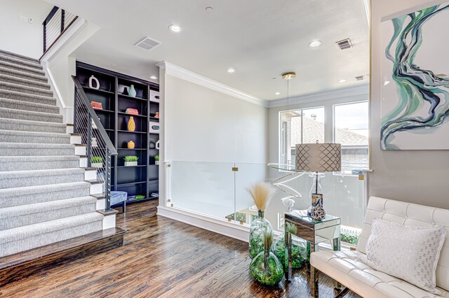 living area featuring ornamental molding and dark hardwood / wood-style flooring