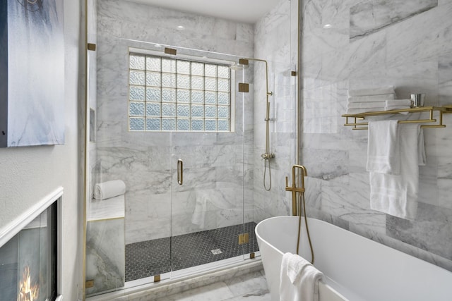 bathroom featuring separate shower and tub