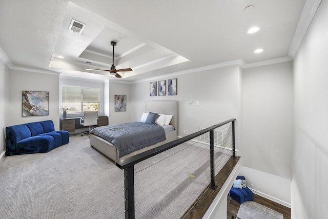 bedroom with crown molding, ceiling fan, and a tray ceiling