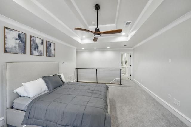 carpeted bedroom featuring a tray ceiling, ornamental molding, and ceiling fan