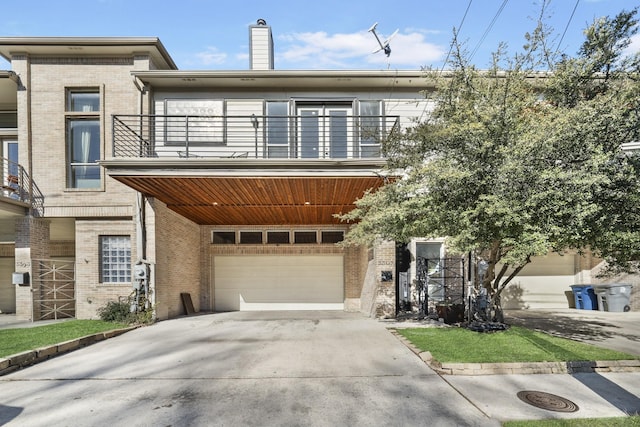 view of front facade featuring a garage and a balcony