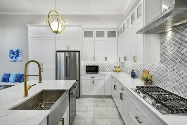 kitchen featuring decorative light fixtures, tasteful backsplash, wall chimney range hood, and stainless steel appliances