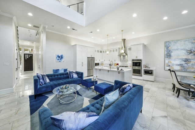 living room with sink and ornamental molding