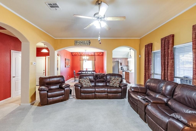 living room featuring crown molding, ceiling fan, and light carpet