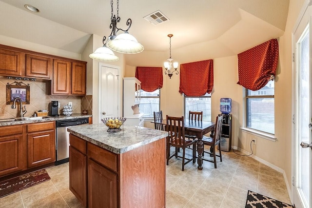 kitchen with sink, a center island, stainless steel dishwasher, pendant lighting, and decorative backsplash